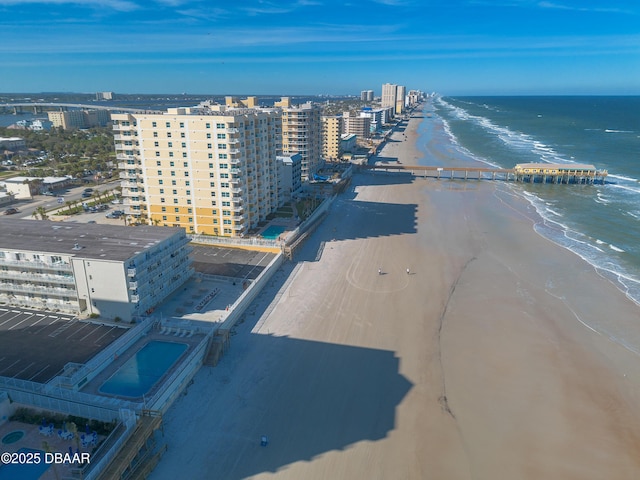 drone / aerial view featuring a water view and a beach view