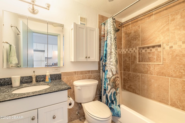 full bathroom with vanity, toilet, shower / bathtub combination with curtain, and tile walls