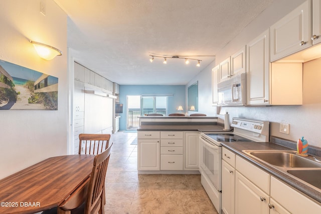 kitchen featuring white cabinetry, white appliances, and sink