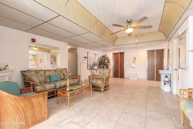 tiled living room featuring a raised ceiling