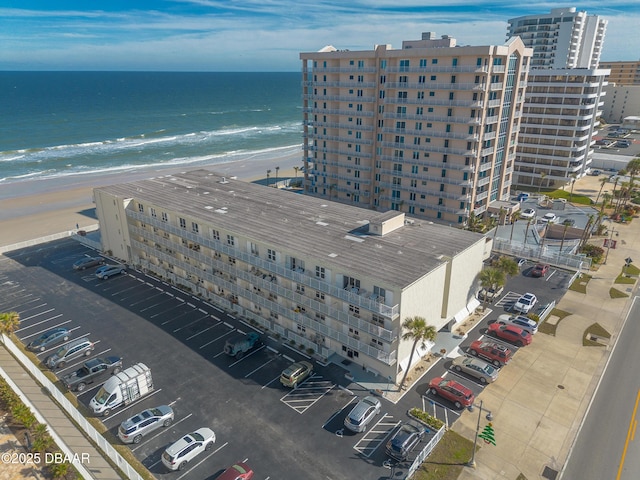 birds eye view of property featuring a view of the beach and a water view