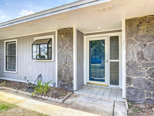 7 Heather Ln, Ormond Beach, FL 32174 - doorway to property featuring stone siding