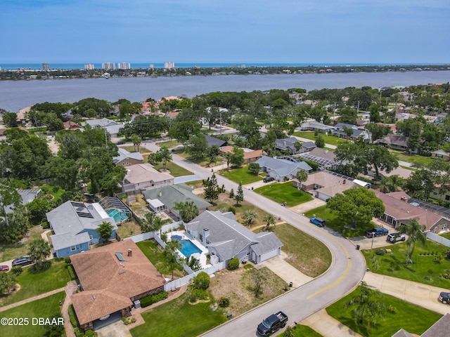 7 Heather Ln, Ormond Beach, FL 32174 - aerial view of property and surrounding area featuring a large body of water, a pool area, and nearby suburban area
