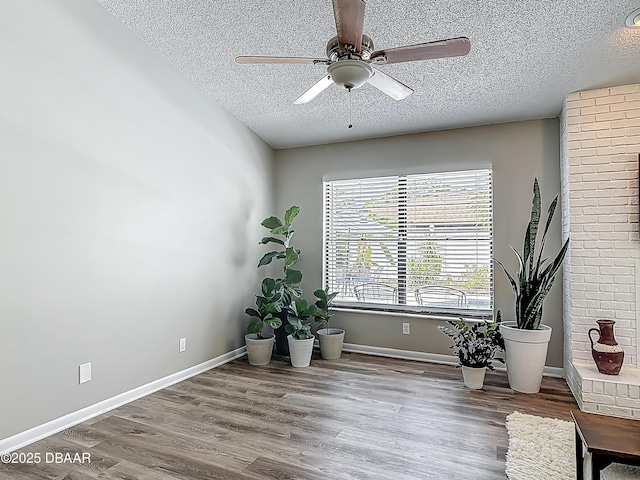 7 Heather Ln, Ormond Beach, FL 32174 - living area featuring a textured ceiling, a ceiling fan, wood finished floors, and baseboards