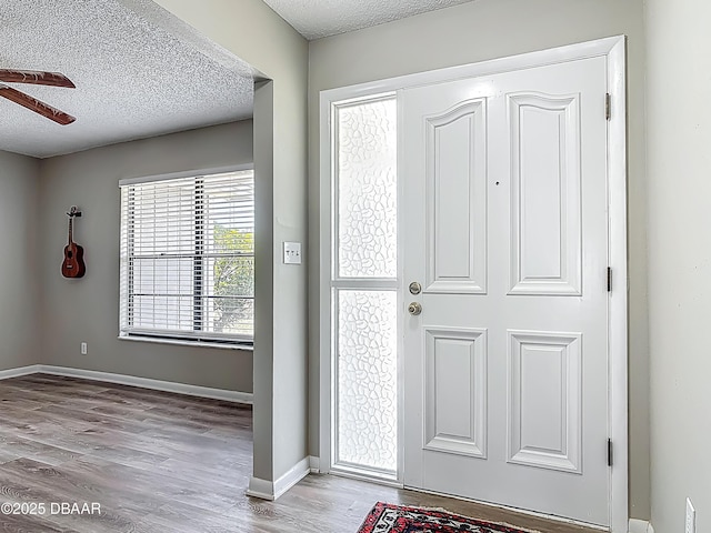 7 Heather Ln, Ormond Beach, FL 32174 - entrance foyer featuring a textured ceiling, ceiling fan, wood finished floors, and baseboards