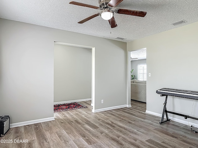 7 Heather Ln, Ormond Beach, FL 32174 - spare room featuring wood finished floors, ceiling fan, a textured ceiling, and baseboards