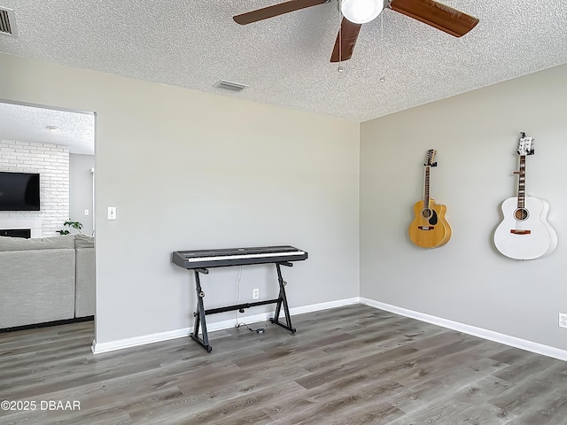 7 Heather Ln, Ormond Beach, FL 32174 - empty room featuring a textured ceiling, wood finished floors, a ceiling fan, and baseboards