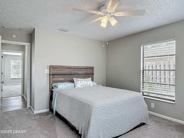 7 Heather Ln, Ormond Beach, FL 32174 - carpeted bedroom featuring a textured ceiling, baseboards, and ceiling fan
