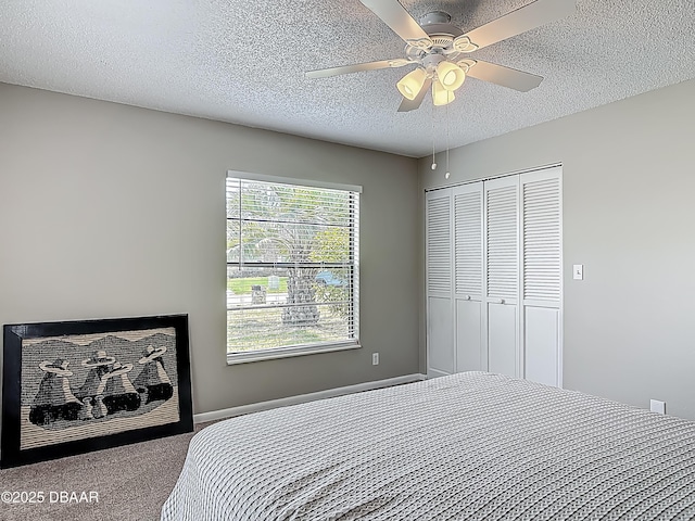7 Heather Ln, Ormond Beach, FL 32174 - bedroom with carpet flooring, a textured ceiling, a closet, and a ceiling fan