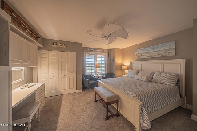 carpeted bedroom with ceiling fan and a closet