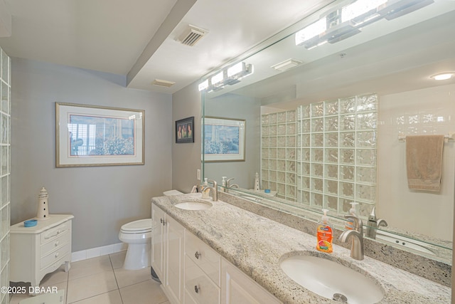 bathroom featuring toilet, vanity, and tile patterned flooring