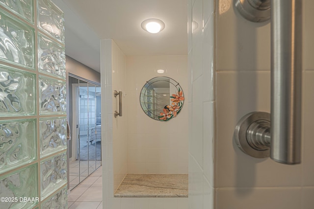 bathroom featuring a tile shower and tile patterned floors