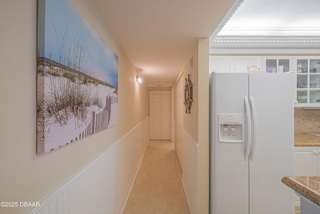 hall with light tile patterned floors