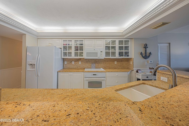 kitchen featuring white cabinetry, sink, white appliances, and crown molding