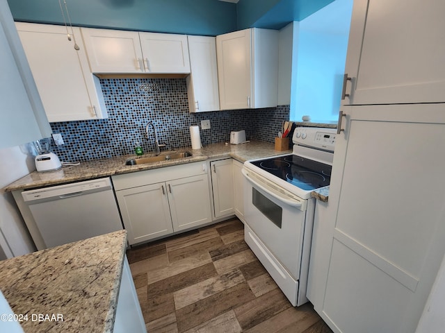 2800 N Atlantic Ave Unit 810, Daytona Beach, FL 32118 - kitchen with white appliances, a sink, white cabinetry, and tasteful backsplash