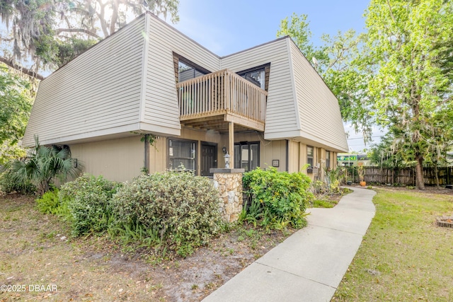 3656 Jackson St Unit 11, Port Orange, FL 32129 - view of front of home featuring fence, a front yard, and a balcony