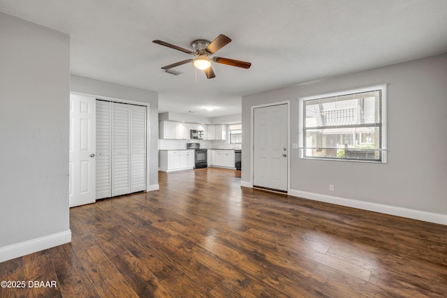 3656 Jackson St Unit 11, Port Orange, FL 32129 - unfurnished living room featuring baseboards, a ceiling fan, and dark wood-type flooring