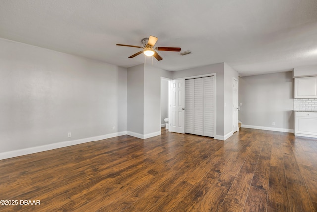 3656 Jackson St Unit 11, Port Orange, FL 32129 - unfurnished bedroom featuring visible vents, a closet, baseboards, dark wood-style flooring, and a ceiling fan