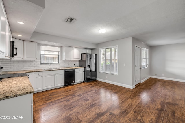 3656 Jackson St Unit 11, Port Orange, FL 32129 - kitchen with a sink, visible vents, baseboards, black appliances, and dark wood-type flooring