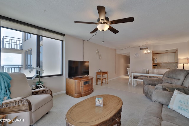 3051 S Atlantic Ave Unit 1806, Daytona Beach Shores, FL 32118 - living room with ceiling fan, light carpet, a chandelier, a textured ceiling, and baseboards