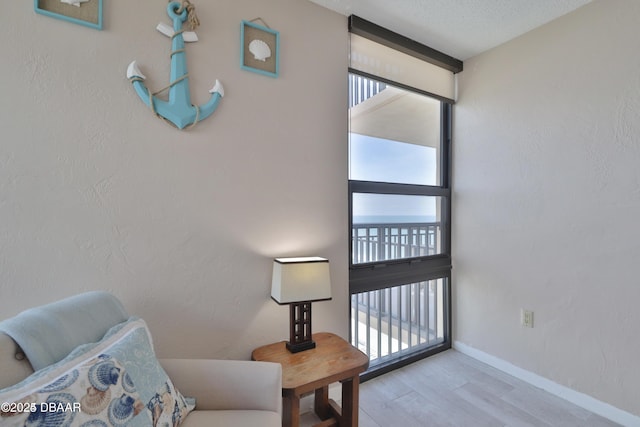 3051 S Atlantic Ave Unit 1806, Daytona Beach Shores, FL 32118 - living area featuring wood finished floors and baseboards