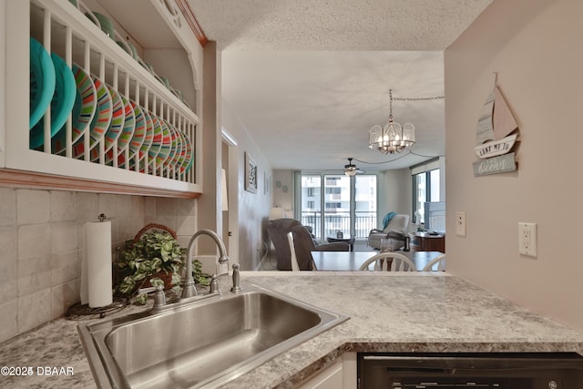 3051 S Atlantic Ave Unit 1806, Daytona Beach Shores, FL 32118 - kitchen with a sink, open floor plan, a chandelier, light countertops, and pendant lighting
