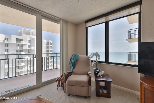 3051 S Atlantic Ave Unit 1806, Daytona Beach Shores, FL 32118 - sitting room with carpet flooring, baseboards, and a textured ceiling