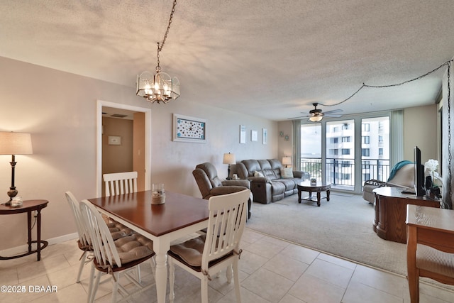 3051 S Atlantic Ave Unit 1806, Daytona Beach Shores, FL 32118 - dining room with light carpet, a textured ceiling, a chandelier, a ceiling fan, and light tile patterned flooring