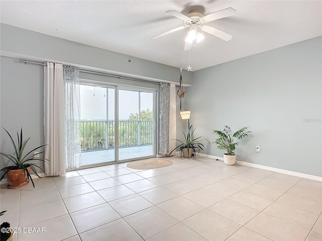 5300 S Atlantic Ave Unit 9-403, New Smyrna Beach, FL 32169 - spare room with light tile patterned floors, baseboards, and ceiling fan