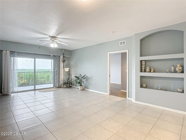 5300 S Atlantic Ave Unit 9-403, New Smyrna Beach, FL 32169 - spare room with baseboards, built in features, a textured ceiling, visible vents, and ceiling fan