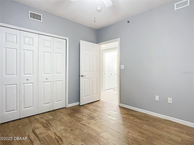 5300 S Atlantic Ave Unit 9-403, New Smyrna Beach, FL 32169 - unfurnished bedroom with wood finished floors, baseboards, a closet, and visible vents
