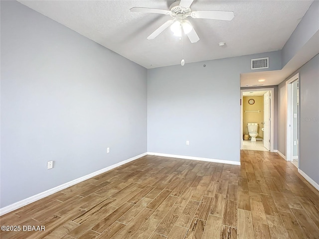 5300 S Atlantic Ave Unit 9-403, New Smyrna Beach, FL 32169 - empty room featuring visible vents, baseboards, a ceiling fan, a textured ceiling, and wood finished floors