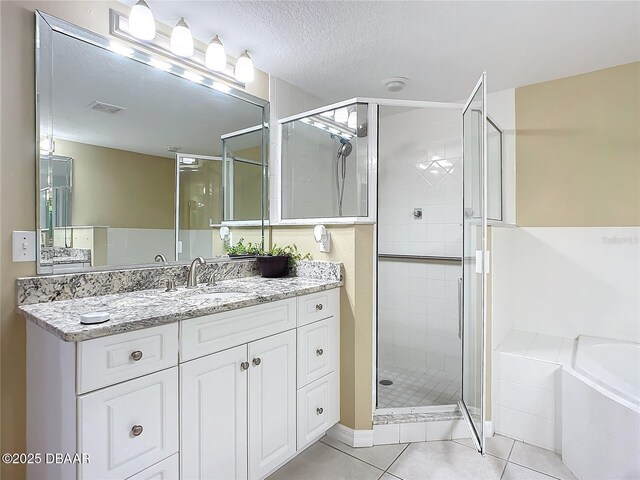 5300 S Atlantic Ave Unit 9-403, New Smyrna Beach, FL 32169 - bathroom with vanity, tile patterned flooring, a shower stall, visible vents, and a bath
