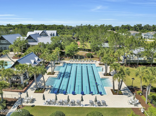 view of pool with a patio area and a lawn