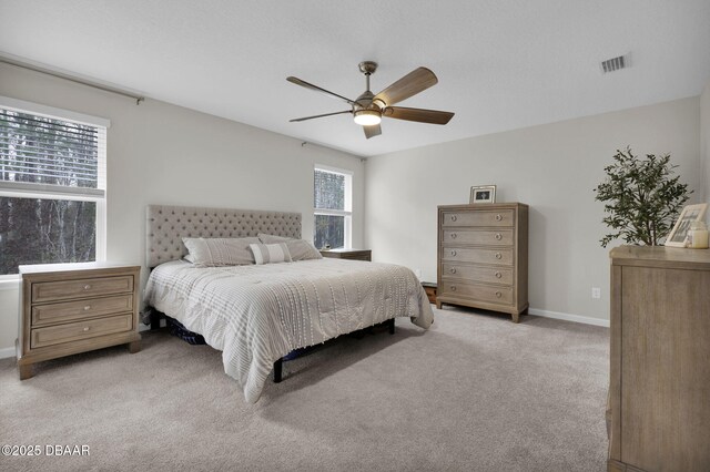 bedroom with multiple windows, carpet, and an inviting chandelier