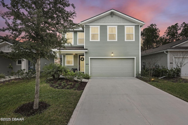 view of front facade with concrete driveway, an attached garage, and a front yard