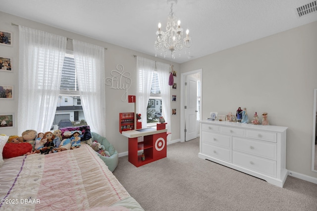 carpeted bedroom featuring a chandelier