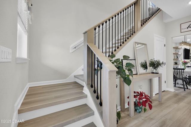 staircase with hardwood / wood-style flooring