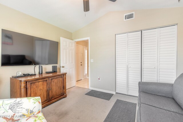 carpeted living room featuring lofted ceiling and ceiling fan