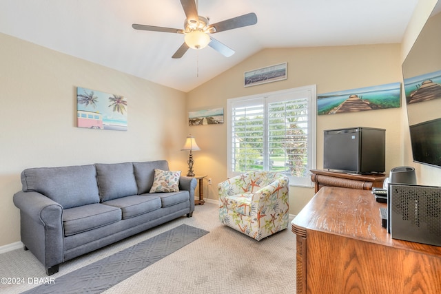 living room with ceiling fan, light colored carpet, and vaulted ceiling