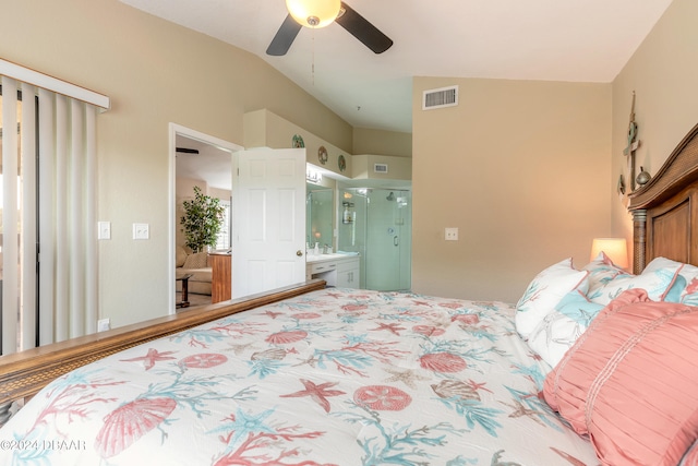 bedroom with ceiling fan, ensuite bath, and lofted ceiling