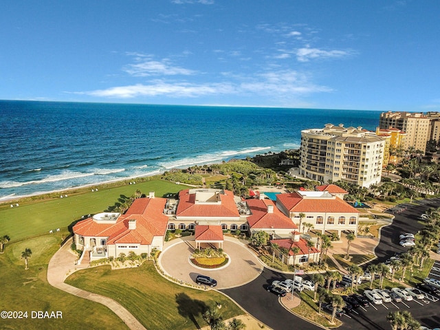 drone / aerial view featuring a beach view and a water view