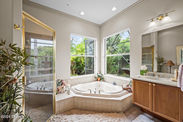 bathroom featuring tiled bath, vanity, tile patterned floors, and crown molding