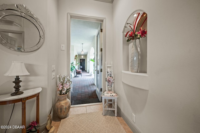 hallway featuring light tile patterned flooring