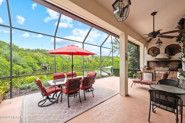 view of patio / terrace featuring a grill, exterior kitchen, a lanai, and ceiling fan