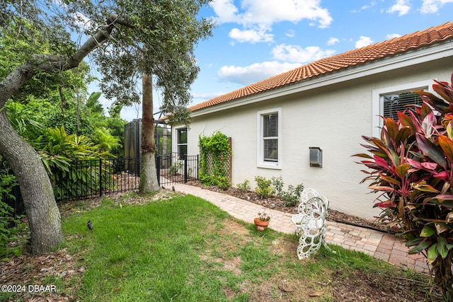 view of side of property with a yard