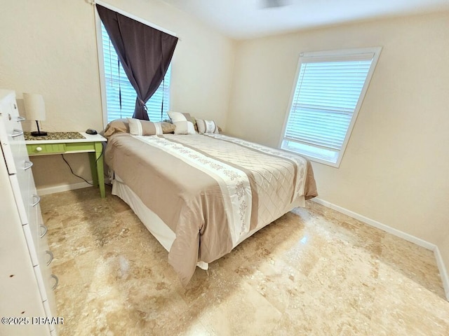 421 University Blvd, Daytona Beach, FL 32118 - bedroom featuring multiple windows and baseboards