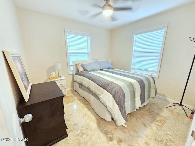 421 University Blvd, Daytona Beach, FL 32118 - bedroom with baseboards and a ceiling fan