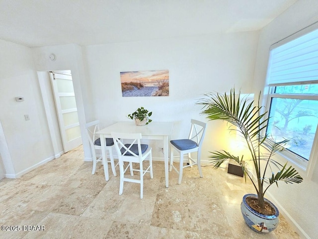421 University Blvd, Daytona Beach, FL 32118 - dining room featuring baseboards and stone finish flooring