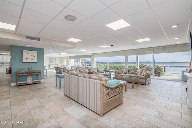 3606 S Peninsula Dr Unit 406, Port Orange, FL 32127 - living room featuring healthy amount of natural light and a paneled ceiling
